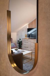 a mirror reflection of a living room with a tv at Theatre 9 Apartments by Adrez in Prague