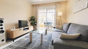 a living room with a couch and a tv at Apartment Fontana Golf Villamartin in Orihuela Costa +23 photos