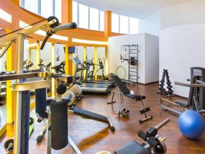 a gym with several treadmills and exercise machines at Novotel St Petersburg Centre in Saint Petersburg