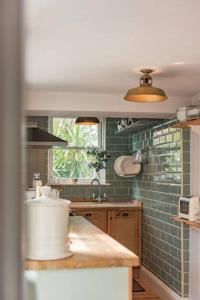 a kitchen with a sink and a window at SeaFern Cottage in Whitstable