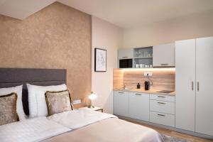 a bedroom with a white bed and a sink at Theatre 9 Apartments by Adrez in Prague