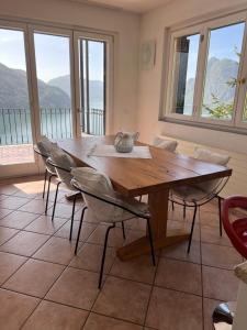 a dining room with a wooden table and chairs at Sweet View in Lugano