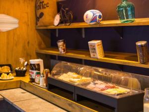 a fast food counter with some food on it at ibis budget Issy Les Moulineaux Paris Ouest in Issy-les-Moulineaux