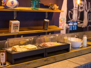 a buffet line with some food on a table at ibis budget Issy Les Moulineaux Paris Ouest in Issy-les-Moulineaux