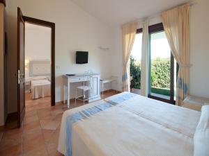 Postel nebo postele na pokoji v ubytování Hotel Costa Caddu