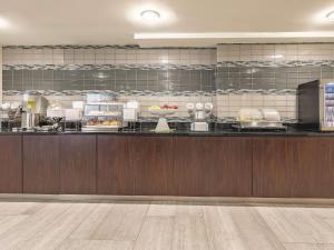 a kitchen with a counter with food on it at La Quinta by Wyndham Portland in Portland