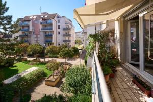 Apartamento con balcón y jardín con árboles y edificios. en Casa Aquarella - Proche Strasbourg, en Schiltigheim