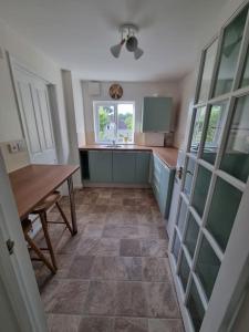 a kitchen with a table and a counter top at Elgar Escape in Barnstaple