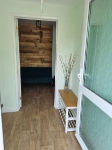 a hallway with a door leading to a room with a table at Elgar Escape in Barnstaple