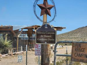 a sign for the siski canyon at desert carats costs at Top Camp Sites at Desert Gardens Oasis at Lobo, Texas 