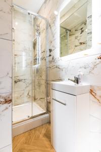 a bathroom with a shower and a sink at Luxury Central Derby Apartment in Derby