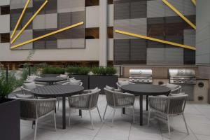 a restaurant with tables and chairs and a grill at Homewood Suites By Hilton Charlotte Uptown First Ward in Charlotte