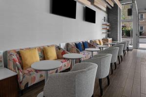 a row of tables and chairs in a waiting room at Homewood Suites By Hilton Charlotte Uptown First Ward in Charlotte