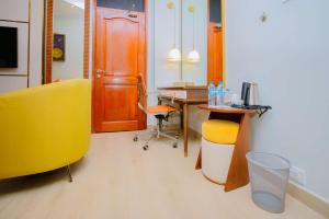 an office with a desk and a yellow chair and a table at Best Western Dodoma City Hotel in Dodoma