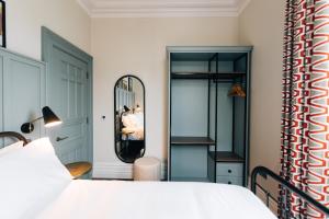 a bedroom with a bed and a mirror at Bank Apartments Portrush in Portrush