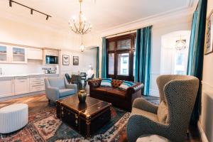 a living room with a couch and chairs and a table at Bank Apartments Portrush in Portrush