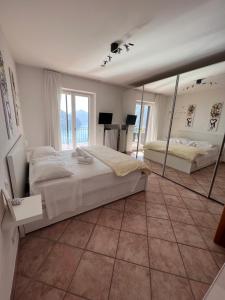 a large bedroom with two beds and a large mirror at Sweet View in Lugano