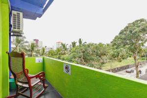 a bench sitting on a balcony with a green wall at Beehive Colombo in Colombo