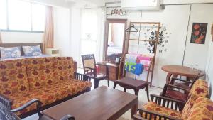 a living room with a couch and chairs and a table at Beehive Colombo in Colombo