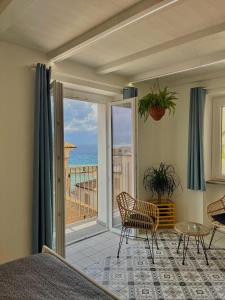 a bedroom with a balcony with a view of the ocean at Casa Vacanze Penelope in Pizzo
