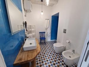 a bathroom with a sink and a toilet at Casa Vacanze Penelope in Pizzo