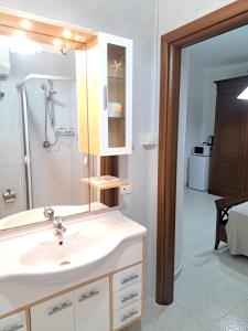 a bathroom with a sink and a shower at La Foggia seaside paradise in Siculiana