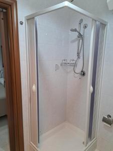 a shower with a glass door in a bathroom at La Foggia seaside paradise in Siculiana