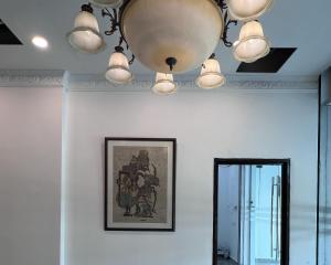 a room with a chandelier and a mirror at Srg Indira Hotel in Gelang Patah