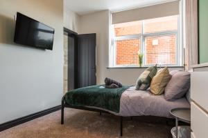 a living room with a couch and a window at Dreamy Derby City Apartment Free Wi-Fi & Parking in Derby