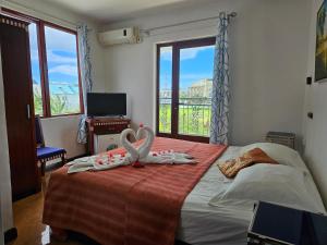 a bedroom with a bed with a large window at Grand Bay Apartments in Grand-Baie