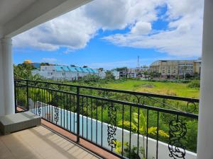 a balcony with a view of a city at Grand Bay Apartments in Grand Baie