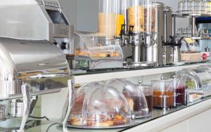 a kitchen with some food in domes on a counter at Kouros Art Hotel (Adults Only) in Stelida