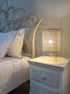 a lamp on top of a dresser next to a bed at Golden Eagle House 