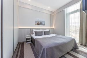 a bedroom with a large bed and a window at Grand Baltic Dunes Hotel & SPA in Palanga