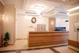 a lobby of a hospital with a clock on the wall at Areen Hotel Al Basateen in Jeddah