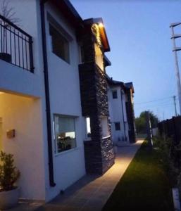 a large white building with a pathway next to it at Del Sol Apart in Sarmiento