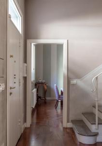 a hallway with a door leading to a room with a table at B&B Arianna in Ravenna