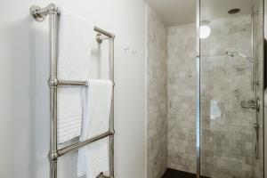 a bathroom with a shower with a glass door at Auberge du Pêcheur in Sint-Martens-Latem