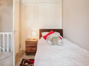 a stuffed teddy bear sitting on top of a bed at Halifax Town House - Cosy - Sleeps 5 in Halifax