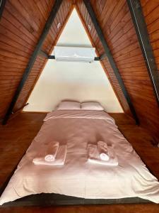 ein Bett in einem kleinen Zimmer mit zwei Handtüchern darauf in der Unterkunft Mira Deluxe Bungalov in Sapanca