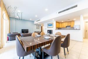 a dining room and living room with a table and chairs at Spacious Modern 1BR in Business Bay in Dubai