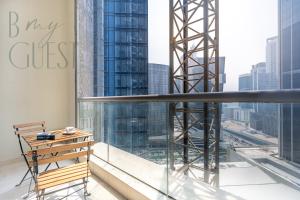 a balcony with a bench and a view of the city at Spacious Modern 1BR in Business Bay in Dubai