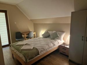 a bedroom with a bed with two towels on it at Noclegi Bumerang in Święta Katarzyna