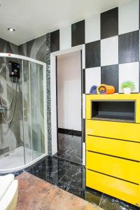 a bathroom with a yellow dresser and a shower at PATONG TOWER FAMILY by PTA in Patong Beach