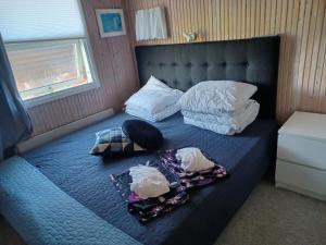 a bed with two pillows and towels on it at Øster Hurup in Hadsund