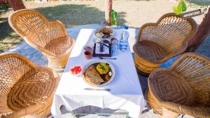 a table with a plate of food on it at Aspen Adventures Camp by Aspen in Rishīkesh