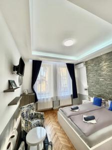 a bedroom with a large bed and a chair at Apartment Nejra in Sarajevo