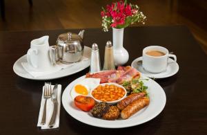 a table with a plate of food and a cup of coffee at The Parkview Hotel in Newtown Mount Kennedy