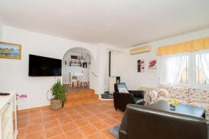 a living room with a couch and a table at Casa Coral Spaniahome in Alfaz del Pi