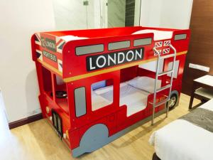 a red double decker bus toy in a room at Southern Airport Hatyai in Hat Yai
